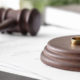 Divorce Rings & Gavel on top of legal paperwork