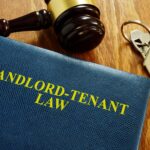 A book outlining tenant rights in Indiana next to a judge's gavel and keys to a home.