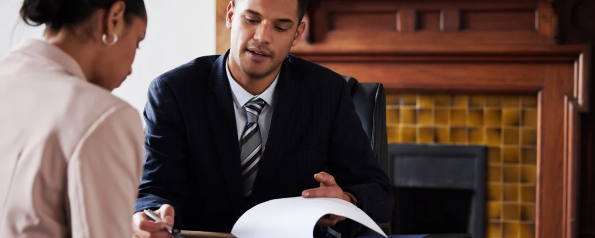 Indiana business lawyer reviewing documents with a female business professional.