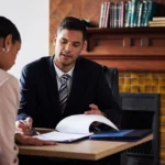 Indiana business lawyer reviewing documents with a female business professional.