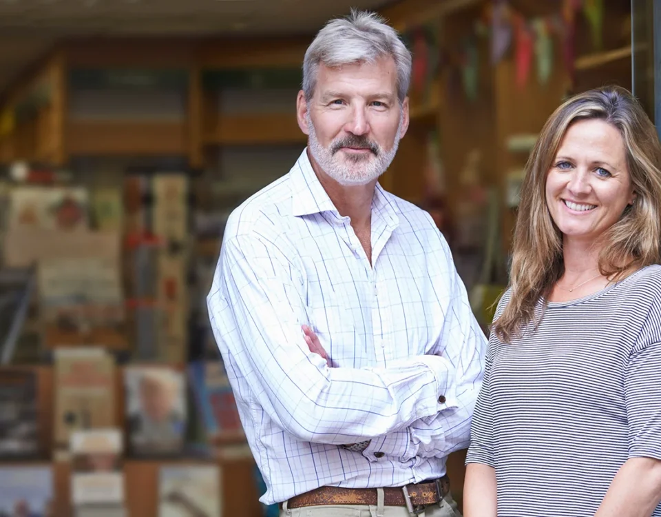 Portrait Of Couple Who Own Bookshop Outside Store